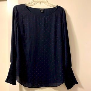 Navy shirt with red polka dots.